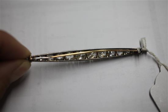 A Victorian gold, silver and graduated old mine cut diamond bar brooch, 85mm.